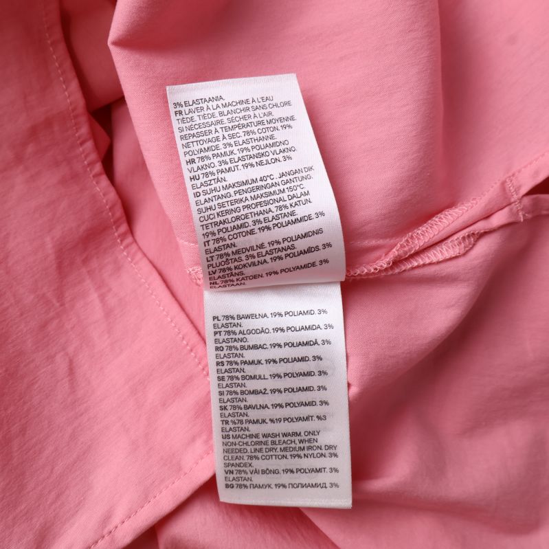 Ytterligare materialetikett på rosa topp