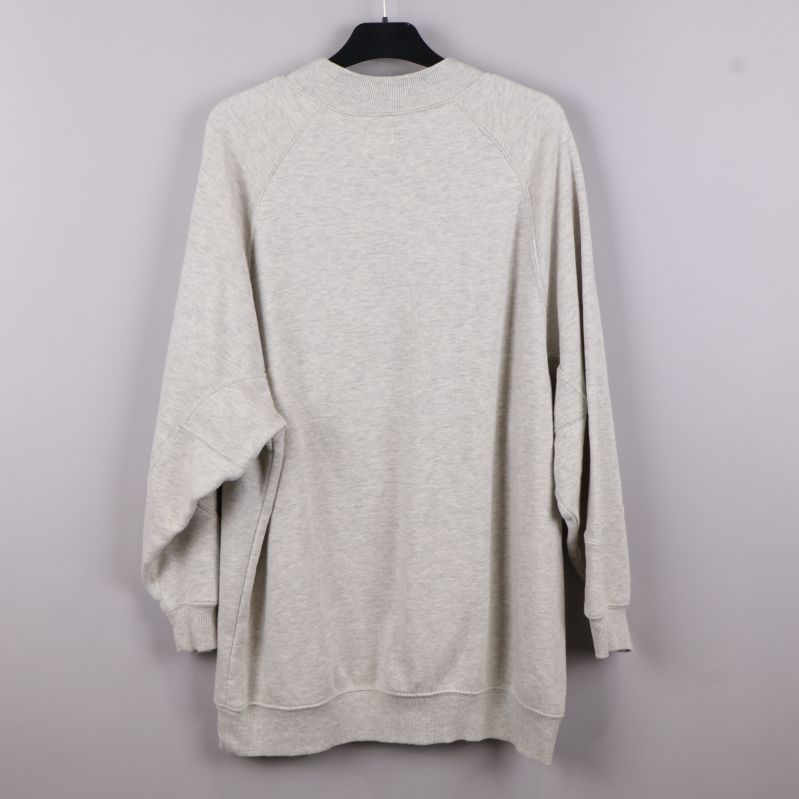 Baksidan av beige tröja med lång ärm