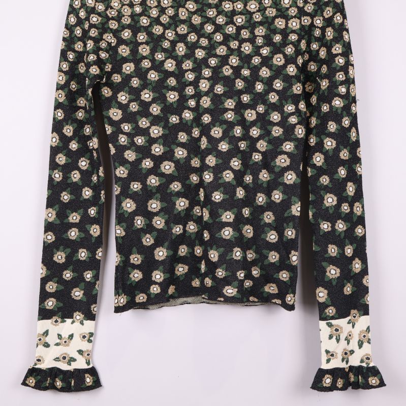 Topps ärmslut med volangdetaljer