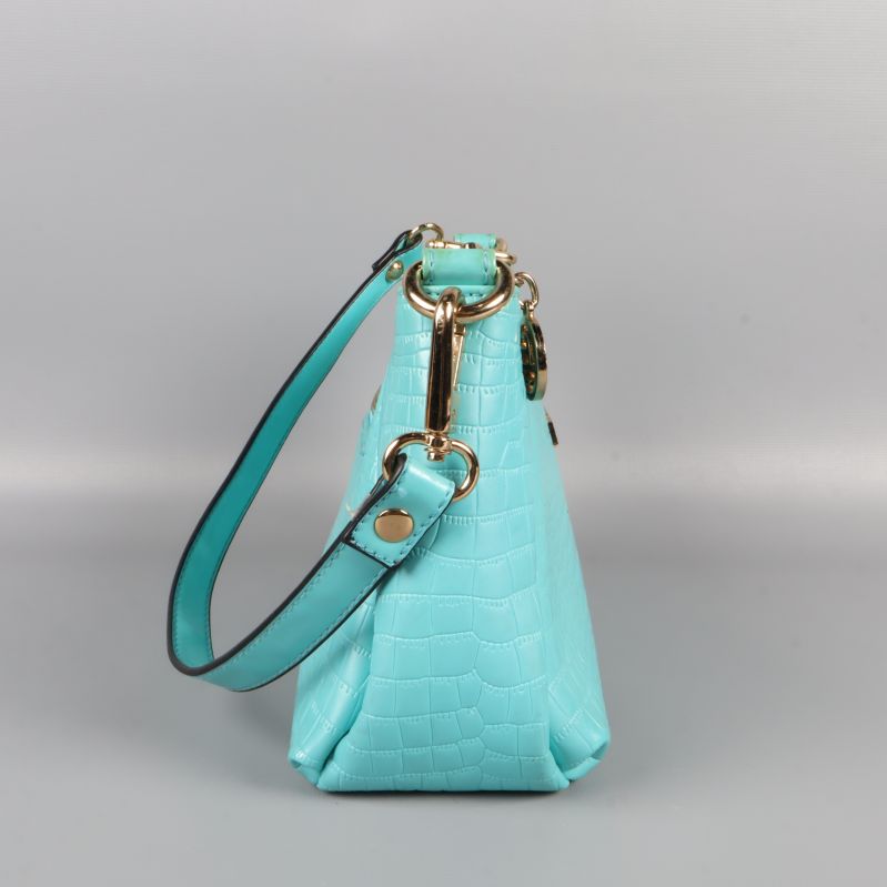 Sidan av turkos handväska med axelrem
