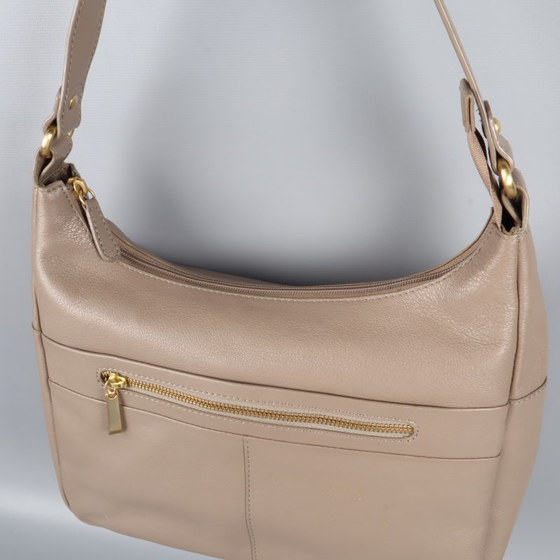 Närbild av dragkedja och rem på väska