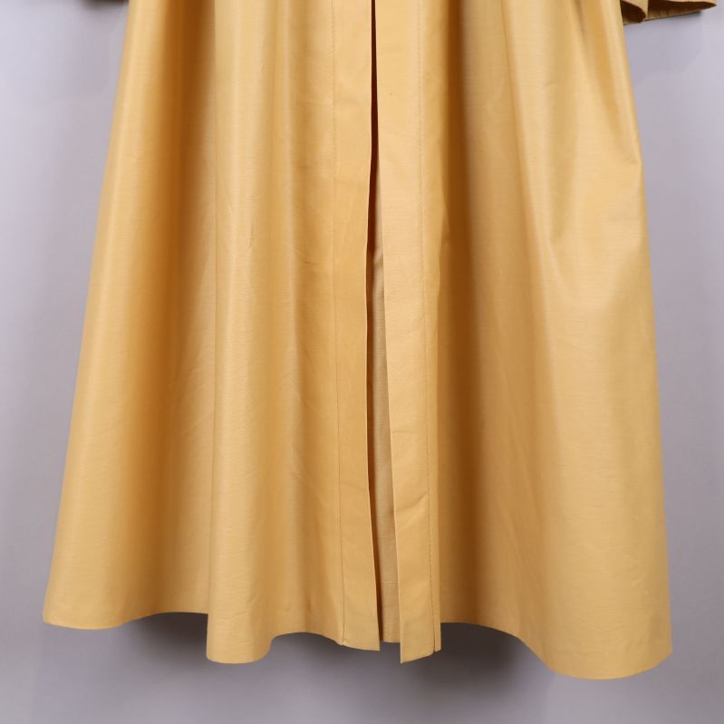 Nedre kant av gul trenchcoat