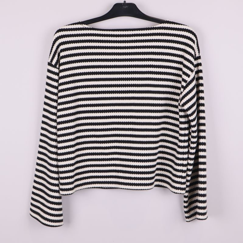 Stickad tröja med svarta och vita horisontella ränder bakifrån