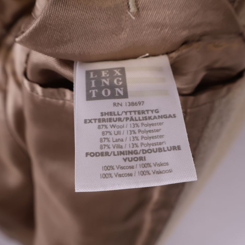 Materialetikett för kappa, visar ull och polyesterblandning