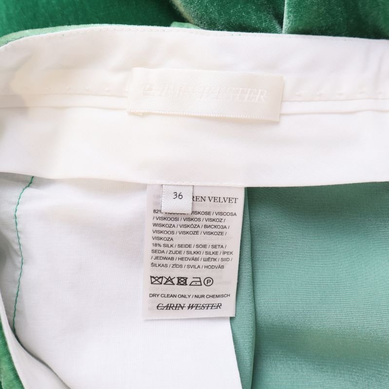 Två inneretiketter i byxlinning som visar material och tvättråd