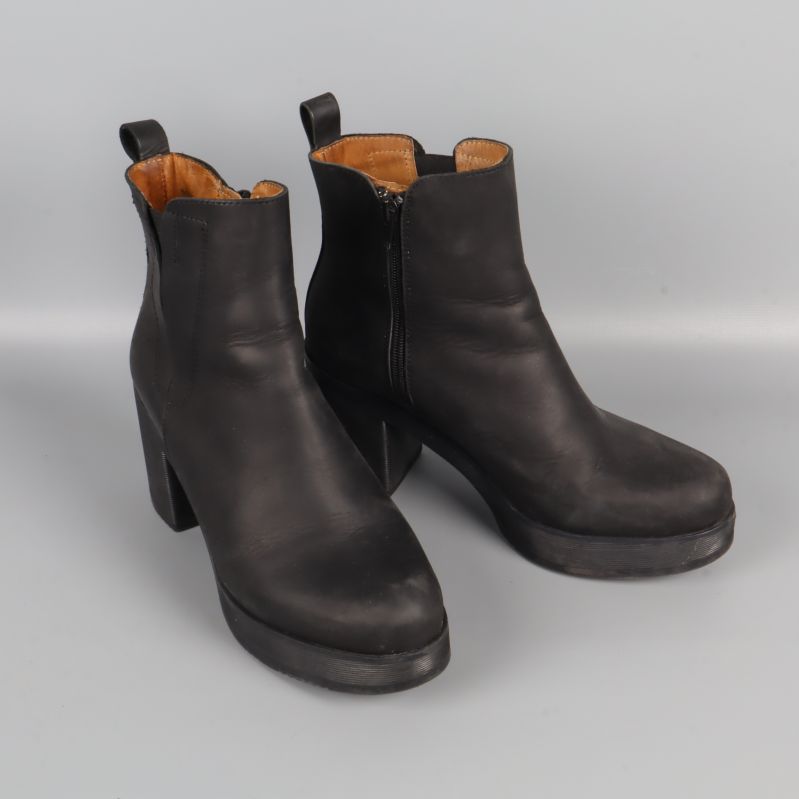 Boots i svart läder, fotade snett framifrån