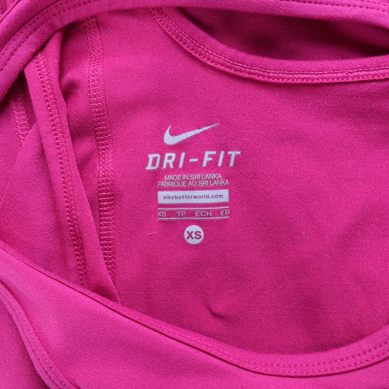 Tryckt etikett med Dri-FIT och storlek XS i sportlinne