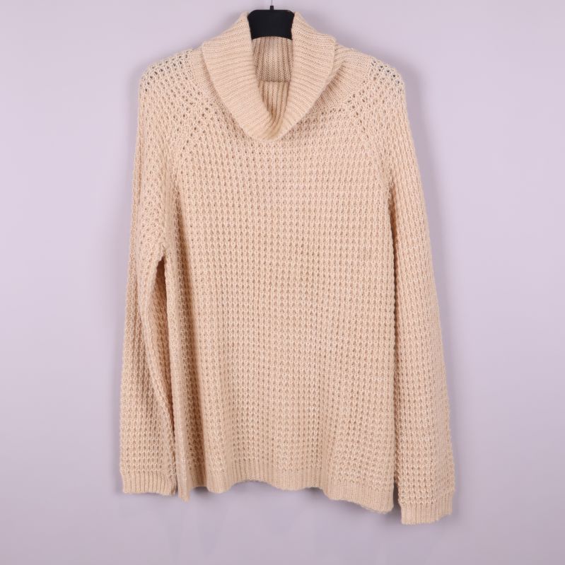 Stickad beige polotröja på galge framifrån