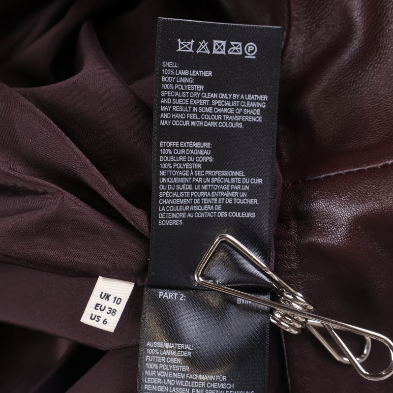 Materialetikett visar 100% lammnappa och storlek EU 38