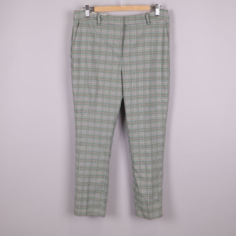 Framsidan av rutiga slacks på galge