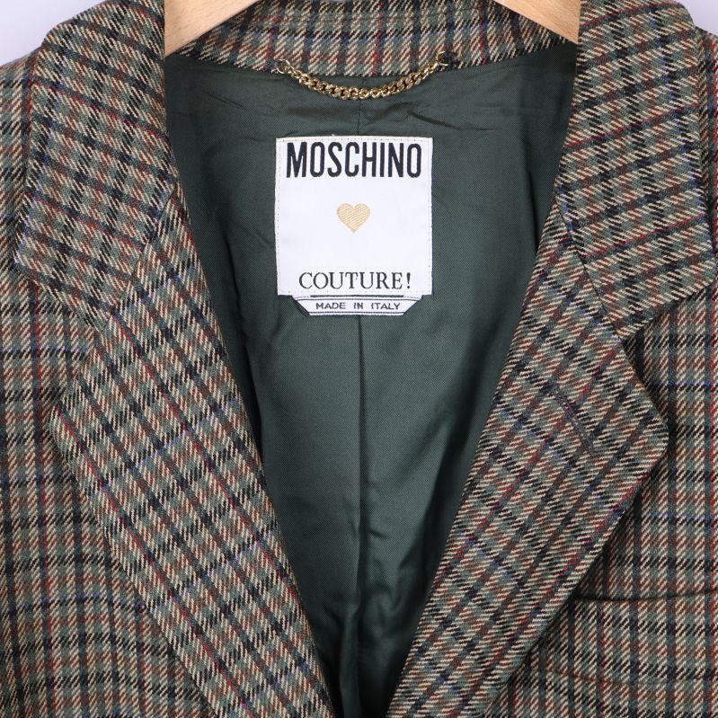 Närbild på Moschino Couture! logotyp och grön insida