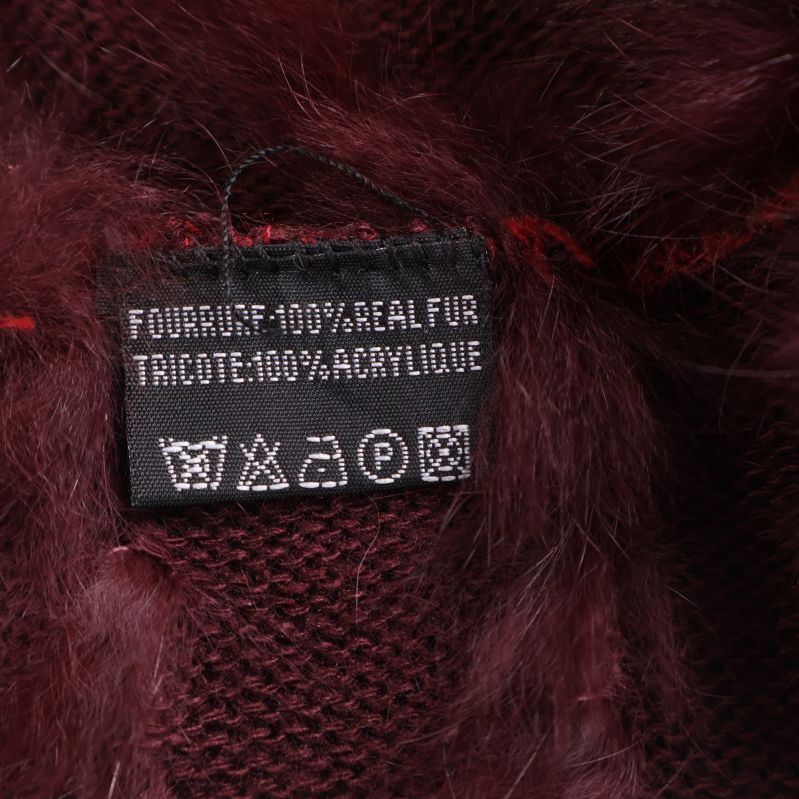 Materiallapp med texten 100% real fur, 100% acrylique