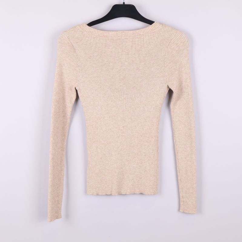 Beige ribbstickad långärmad tröja bakifrån