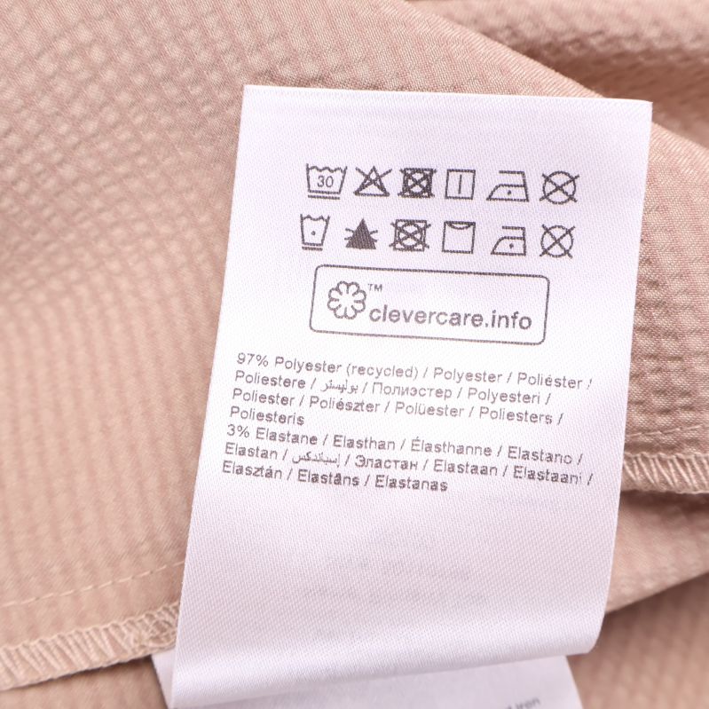 Materiallapp visar komposition polyester och elastan