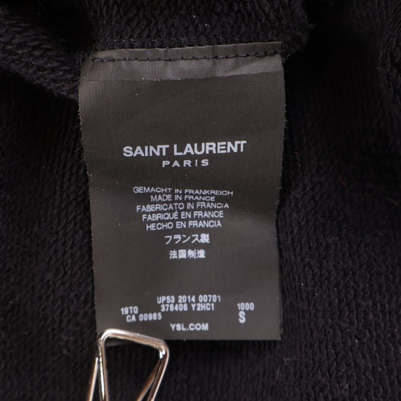Svart inneretikett med Saint Laurent Paris logotyp och tillverkningsinformation