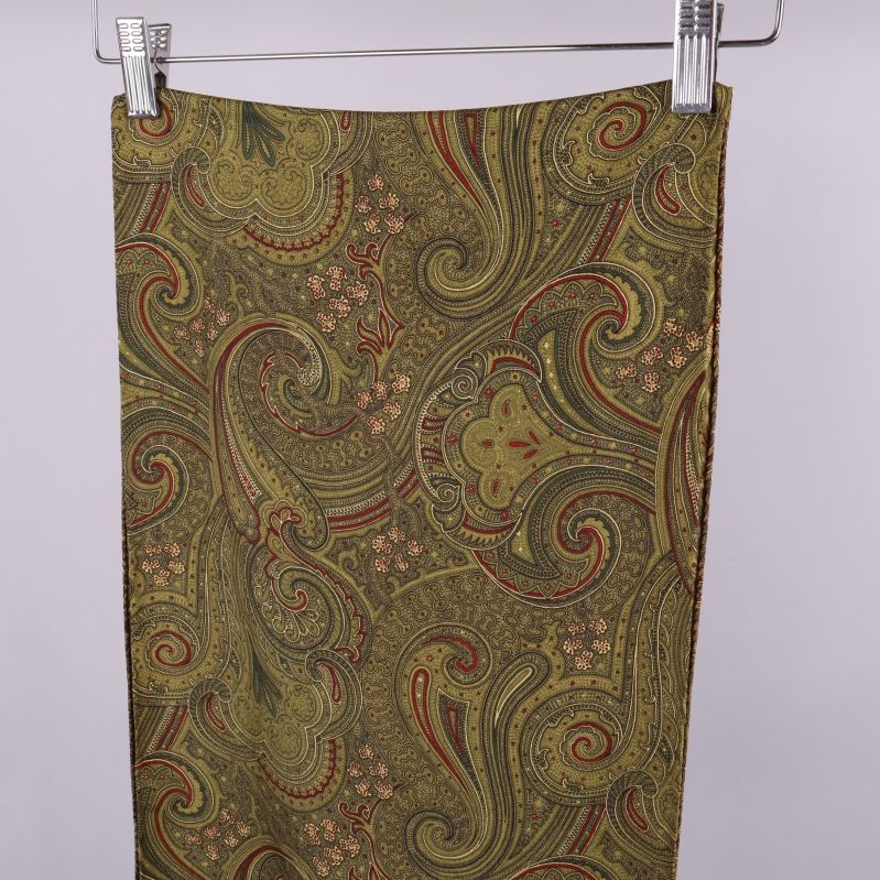 Närbild på sjalens paisleymönster i gröna toner