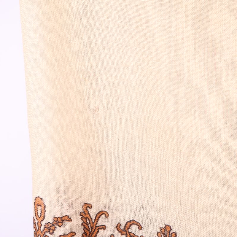 Närbild på ljus tygdel utan tydligt mönster på sjalen