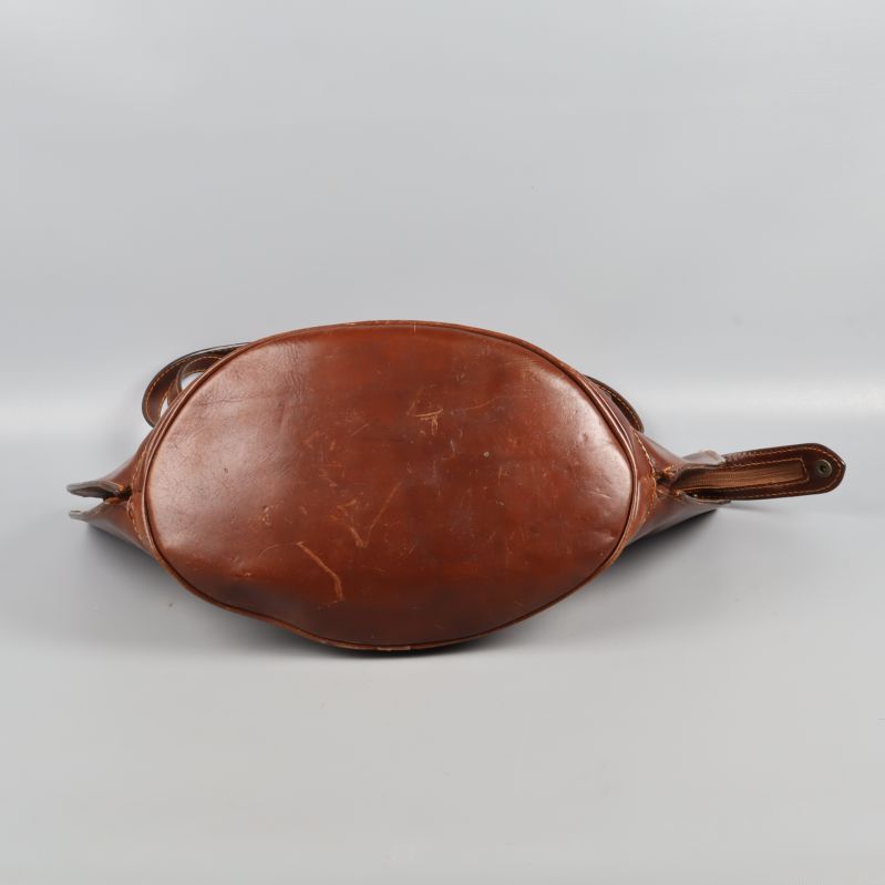 Undersidan av brun läderväska med lätt slitning