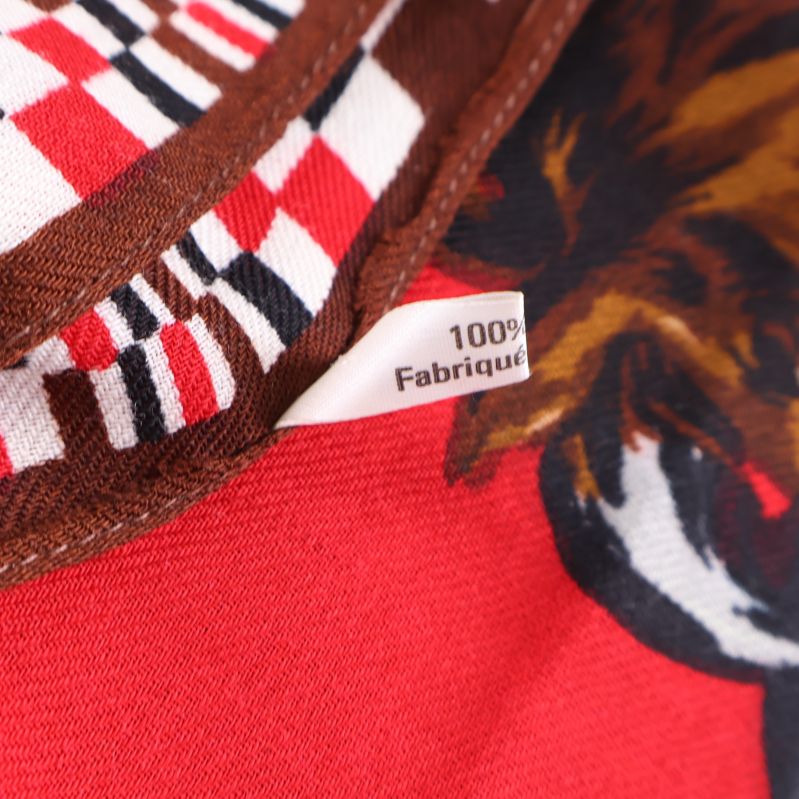 Tygmärke som visar 100% laine på sjalen