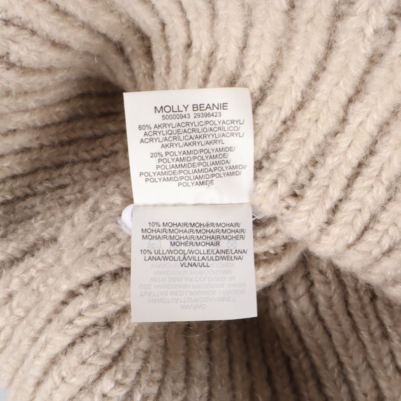 Materialetikett med information om ull och akrylfiber