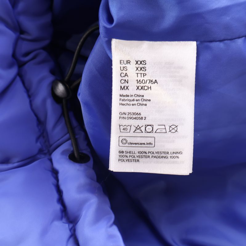 Materiallapp som visar 100% polyester på jacka