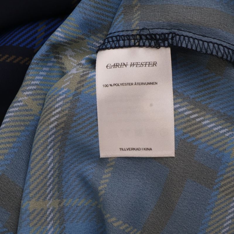 Materialetikett som anger 100% polyester