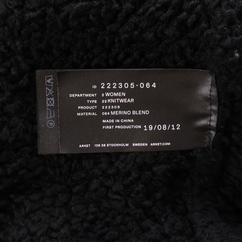 Material- och skötselrådslapp med information om merinoullsblandning