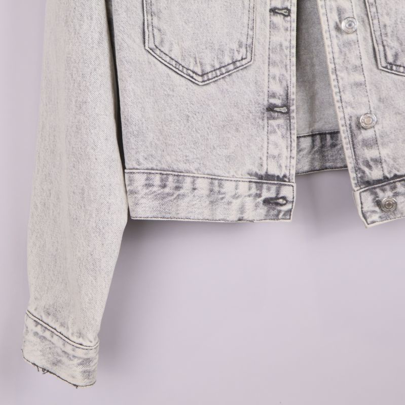 Närbild på underkant och ärmslut på jeansjacka