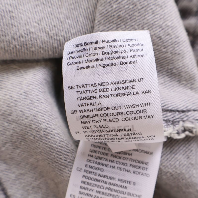 Tvättlapp med materialinfo 100% bomull i jeansjacka