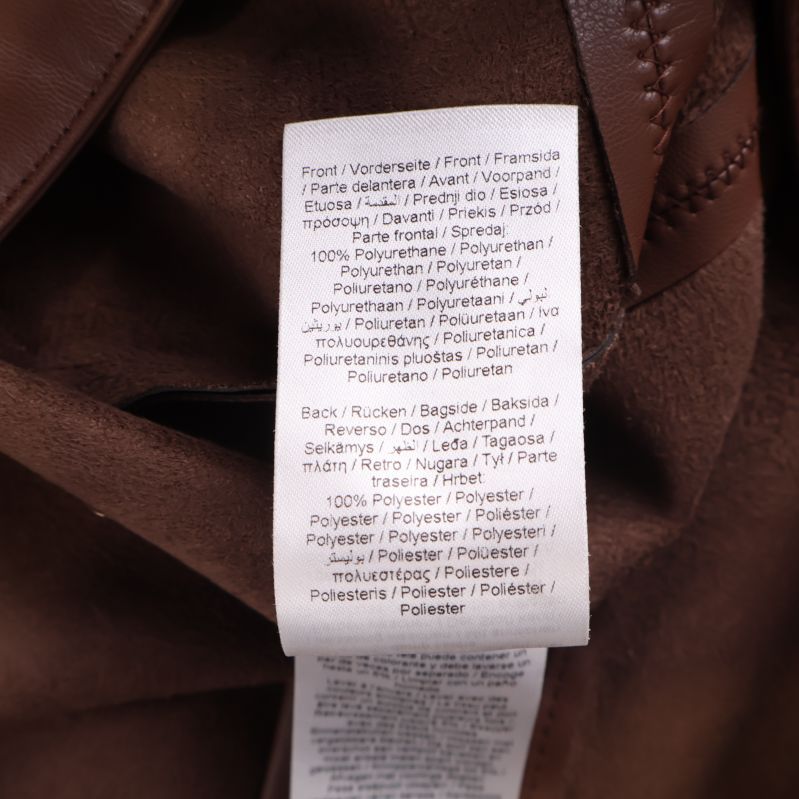 Materiallapp med information om material på brun kjol
