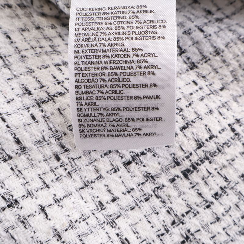 Materiallapp med information om 85% bomull, 7% akryl, 7% polyester