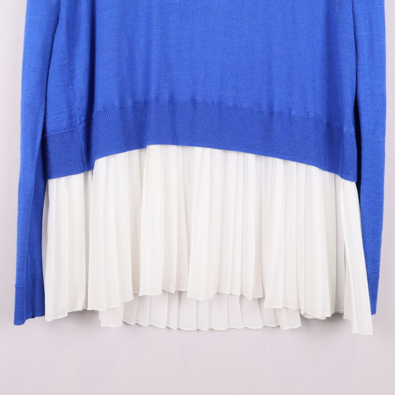 Närbild på vit plisserad nederkant