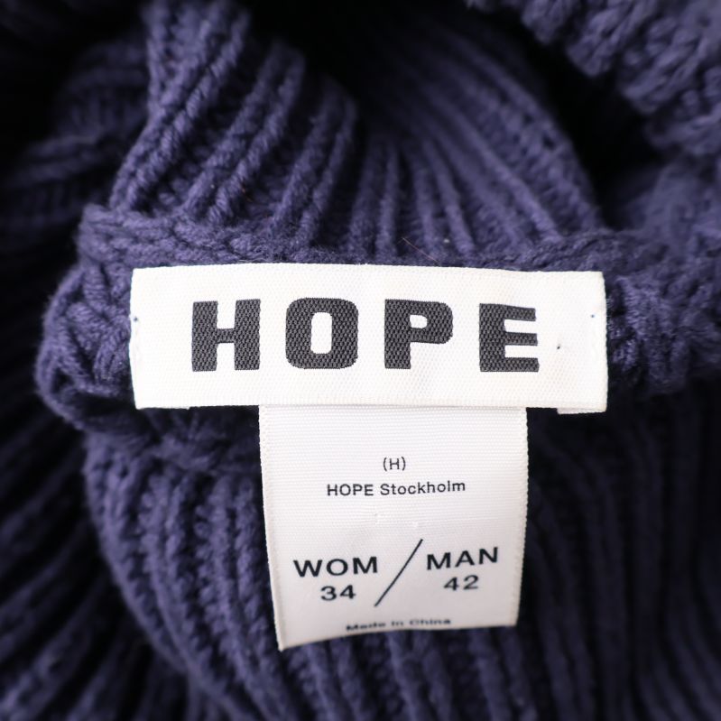 HOPE Stockholm-plaggetikett med storleksinformation