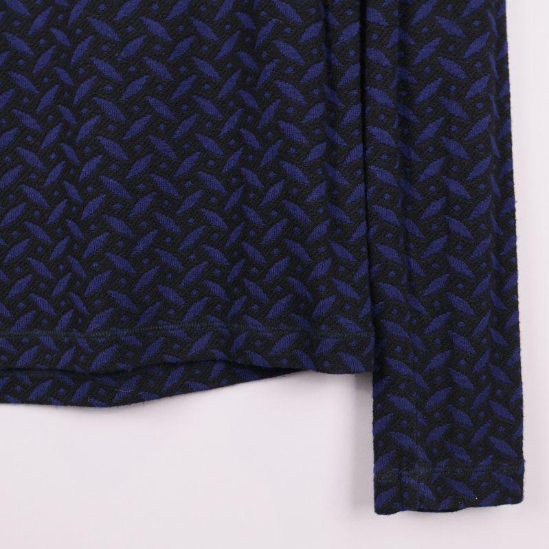 Närbild av ärmslut och mönster på polotröja