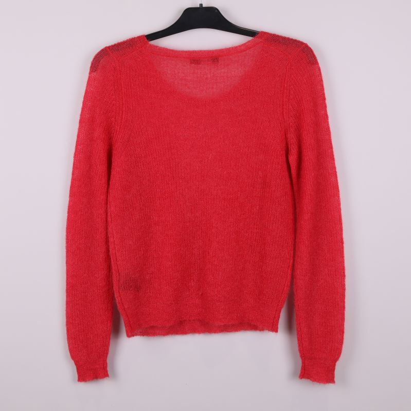 Baksida av röd stickad tröja med lång ärm