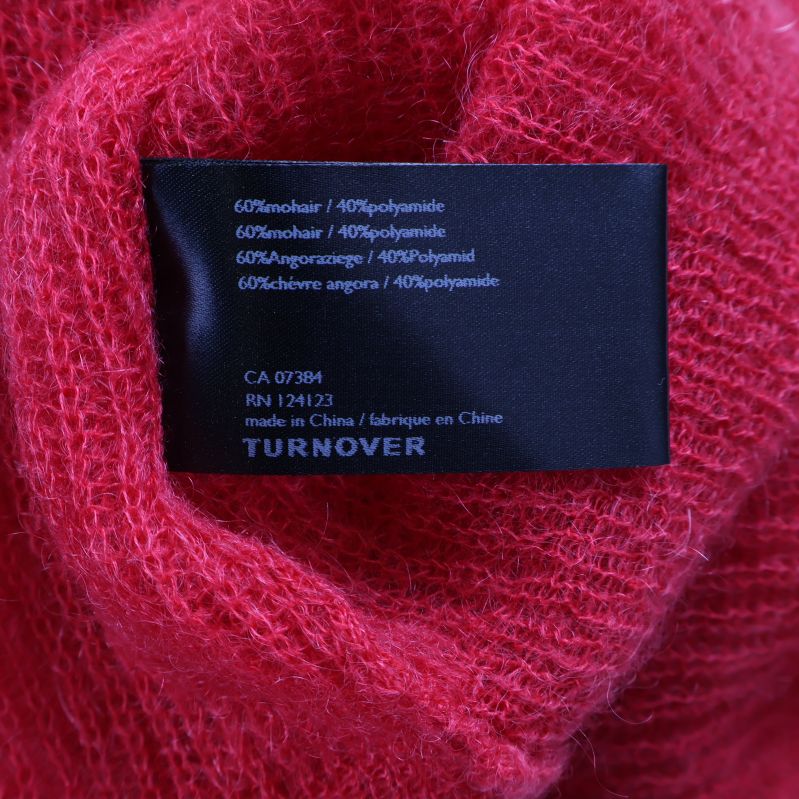 Materialetikett visar mohair, angora och polyamid-blandning