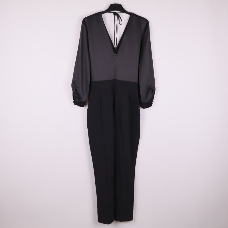 Svart byxdress sedd bakifrån med knytning i nacken