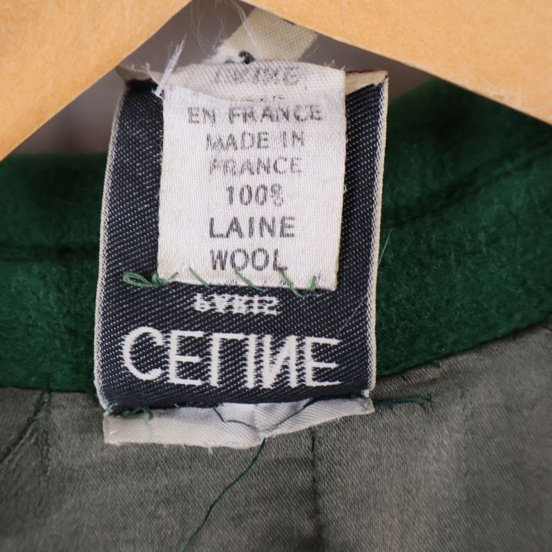 Materialetikett som visar 100% ull och tillverkad i Frankrike