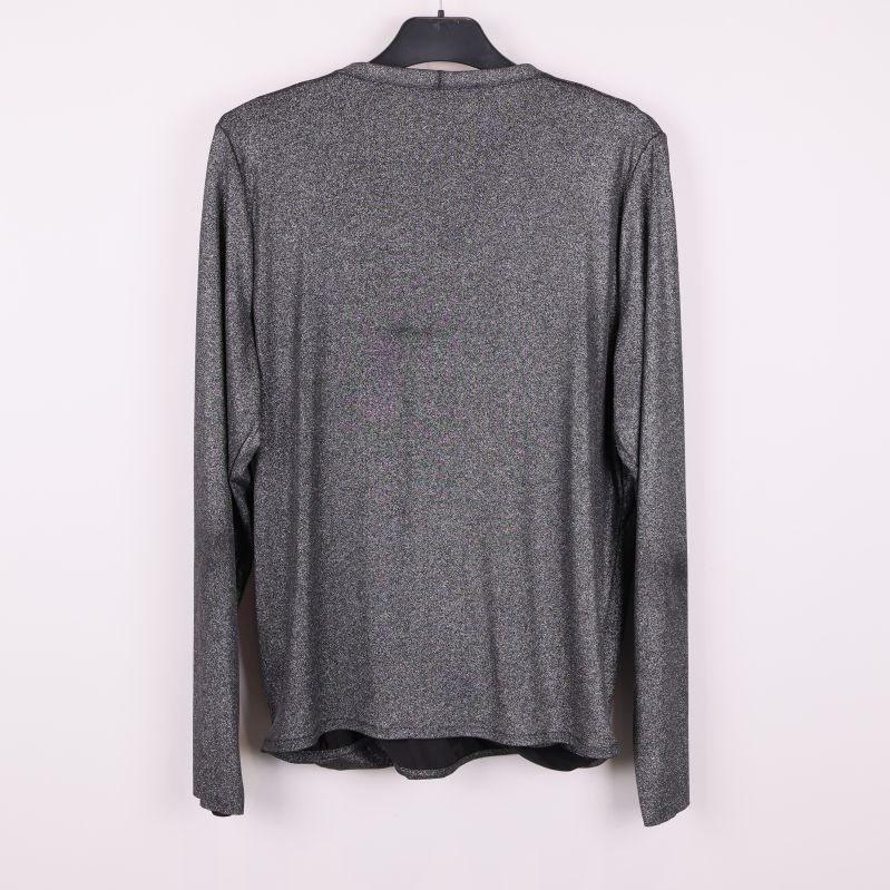 Baksida av topp med glittrig finish och långa ärmar