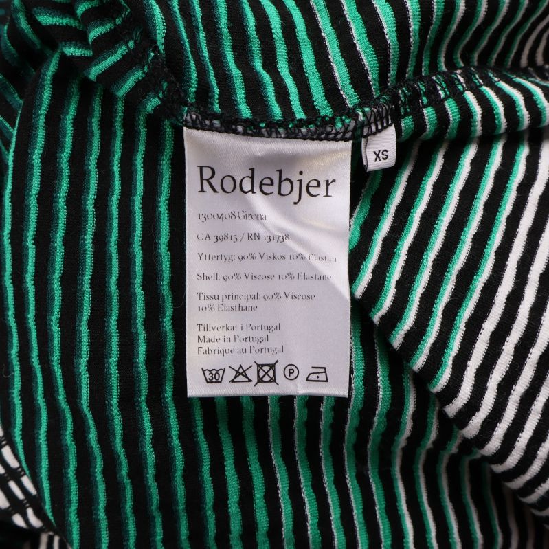 Material- och tvättrådsetikett från Rodebjer med storlek XS