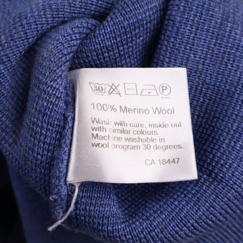 Tvättrådslapp som visar 100% merinoull