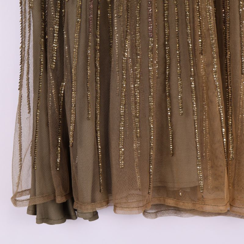 Nedre delen av kjolen med paljetter och transparent mesh