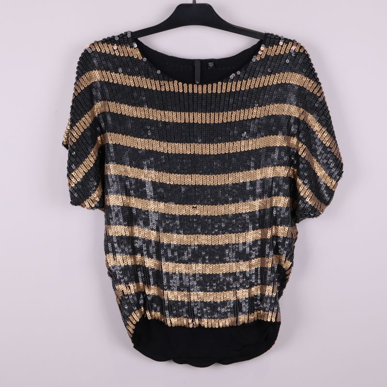 Framsida av topp med svarta och bronsfärgade paljettränder