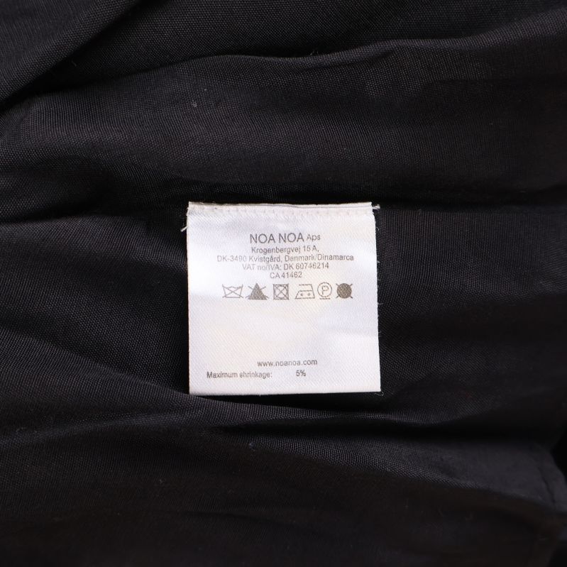 Tvätt- och materialetikett med detaljerade instruktioner