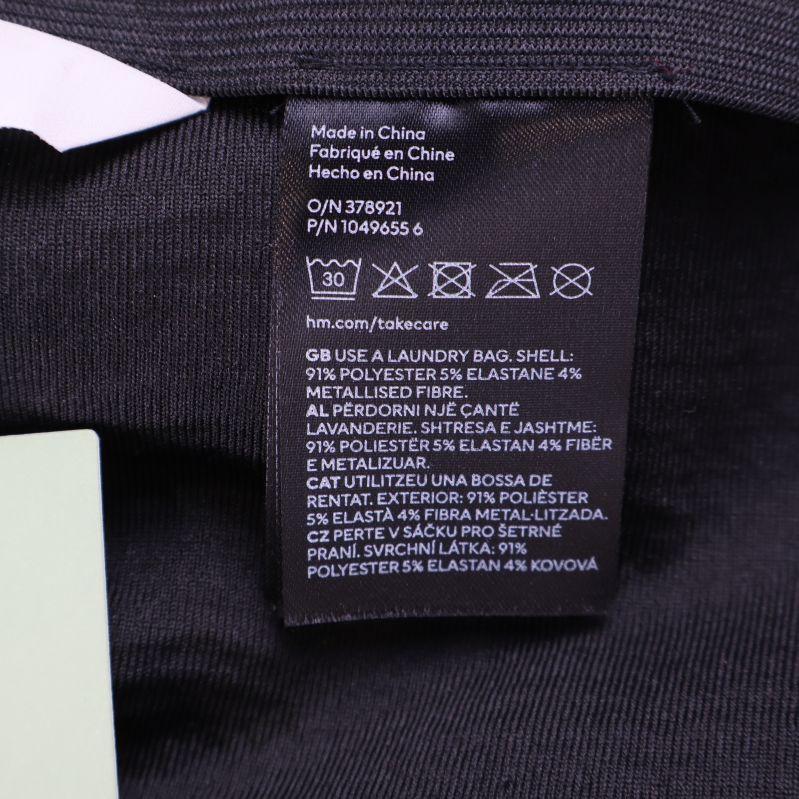 Materialetikett som visar komposition och tvättråd