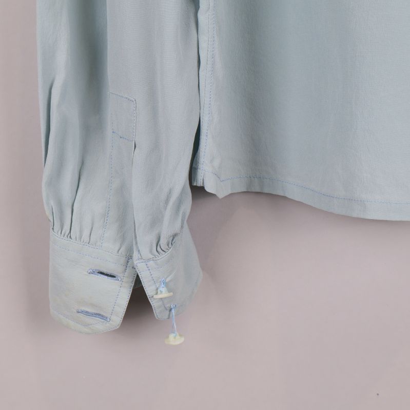 Ärmslut med manschett och knäppning på blus