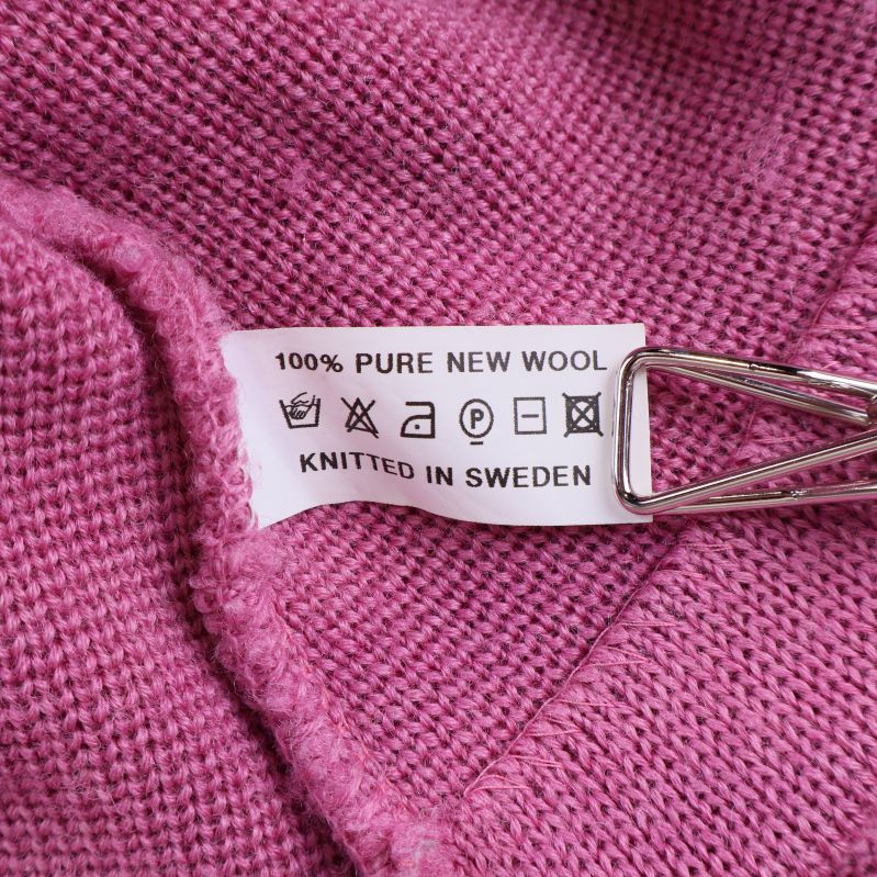 Materiallapp med texten 100% pure new wool