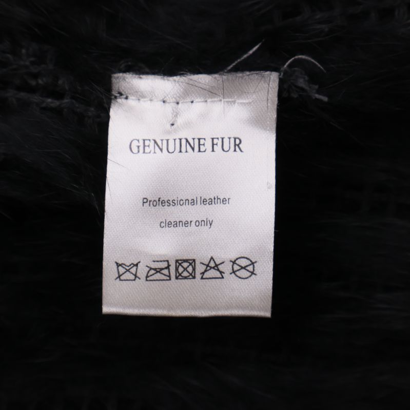 Etikett genuin päls och skötselråd på svart väst