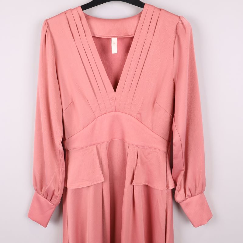 Närbild på livet och ärmslut på rosa klänning