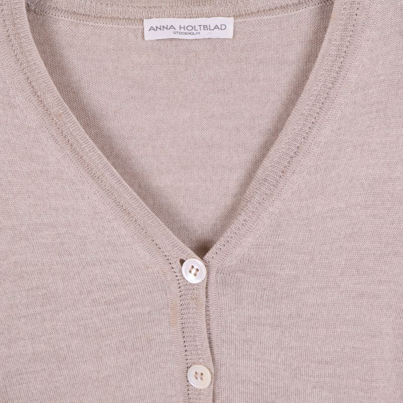 Närbild på halsringning och etikett i koftan